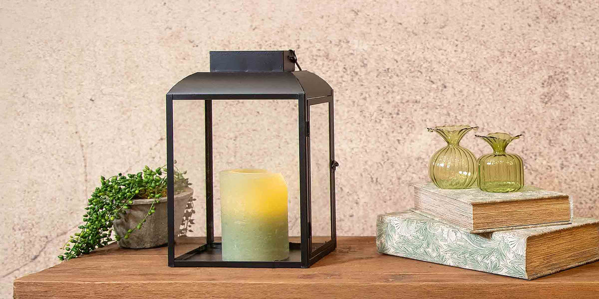 Image of Black Lantern with Green Candle by Floral Book Boxes and Bud Vases