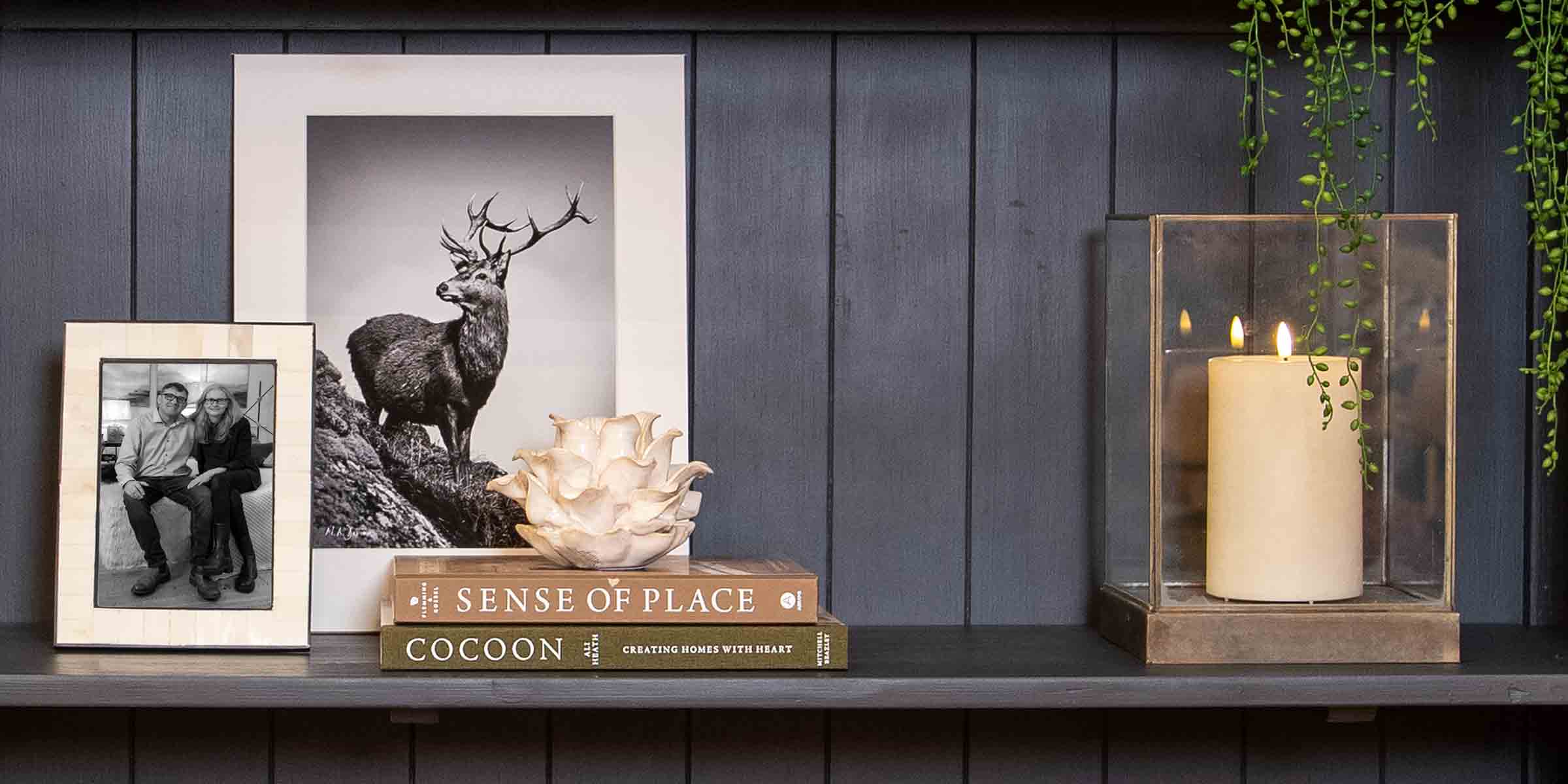 Image of Bookshelf Styled with Candle Holder, Books and Photo Frame