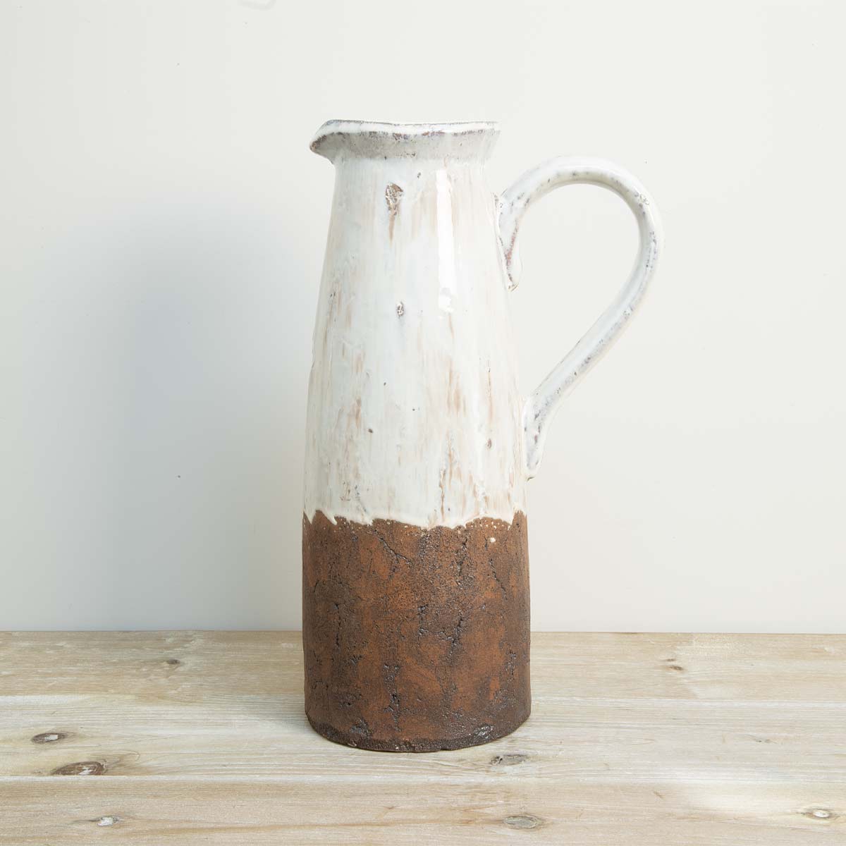 Small rustic ceramic vase with handle in cream and brown terracotta