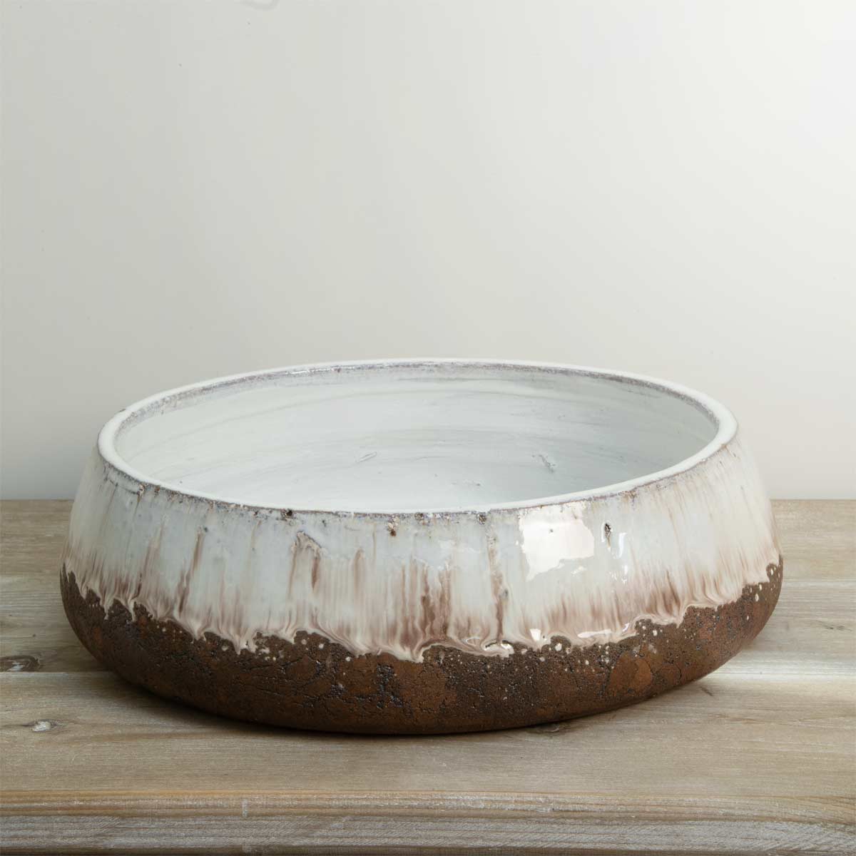 Low terracotta decorative bowl with aged cream glaze and rustic brown base