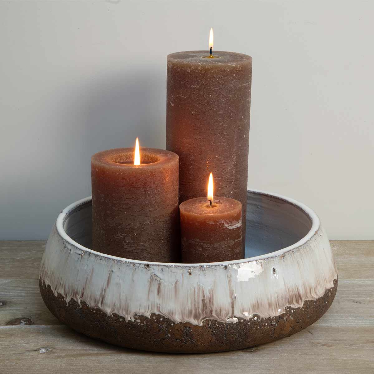 Low terracotta decorative bowl with aged cream glaze and rustic brown base - displated with coffee pillar candles