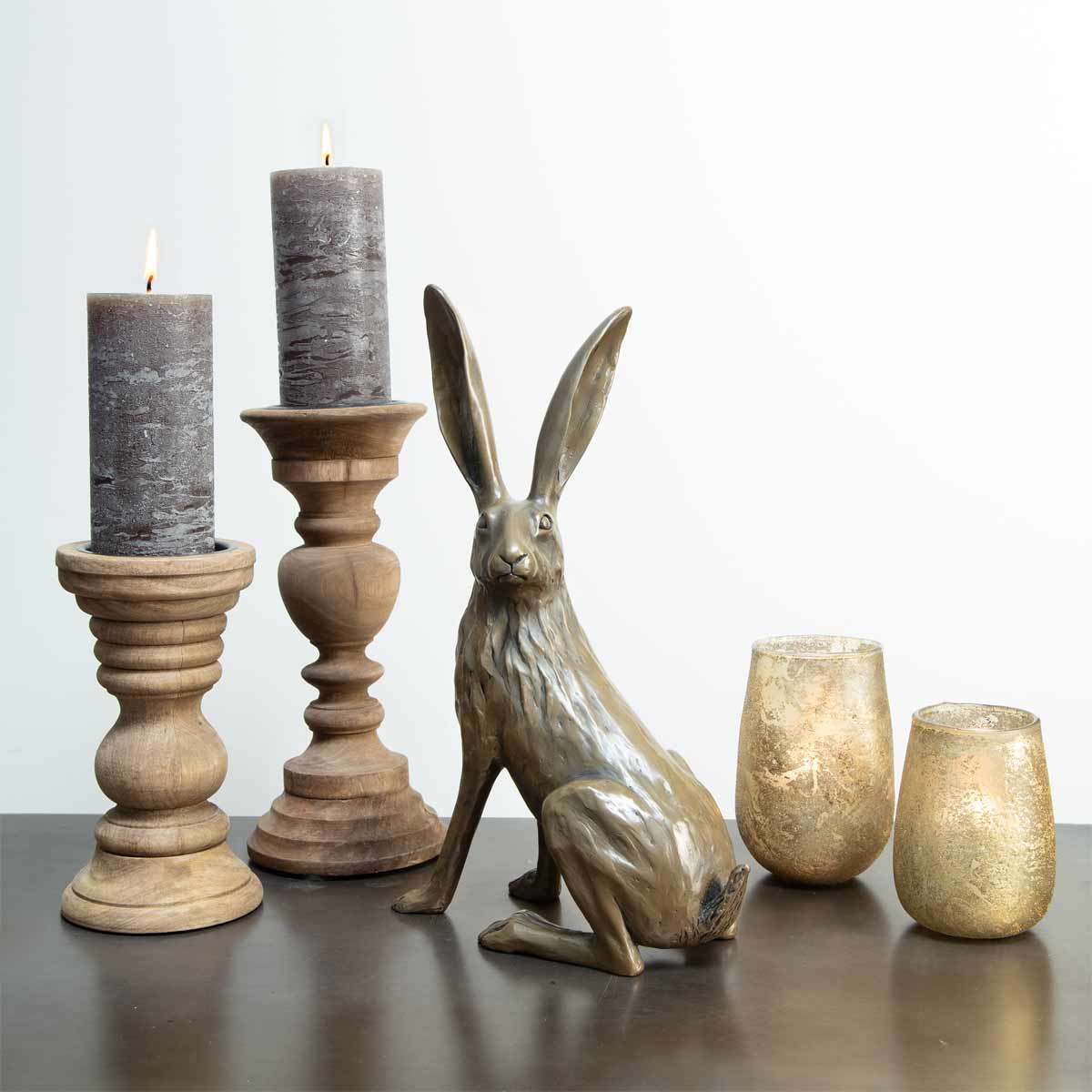 All Ears Hare Bronze Resin Sculpture - Displayed with candles and votives on table