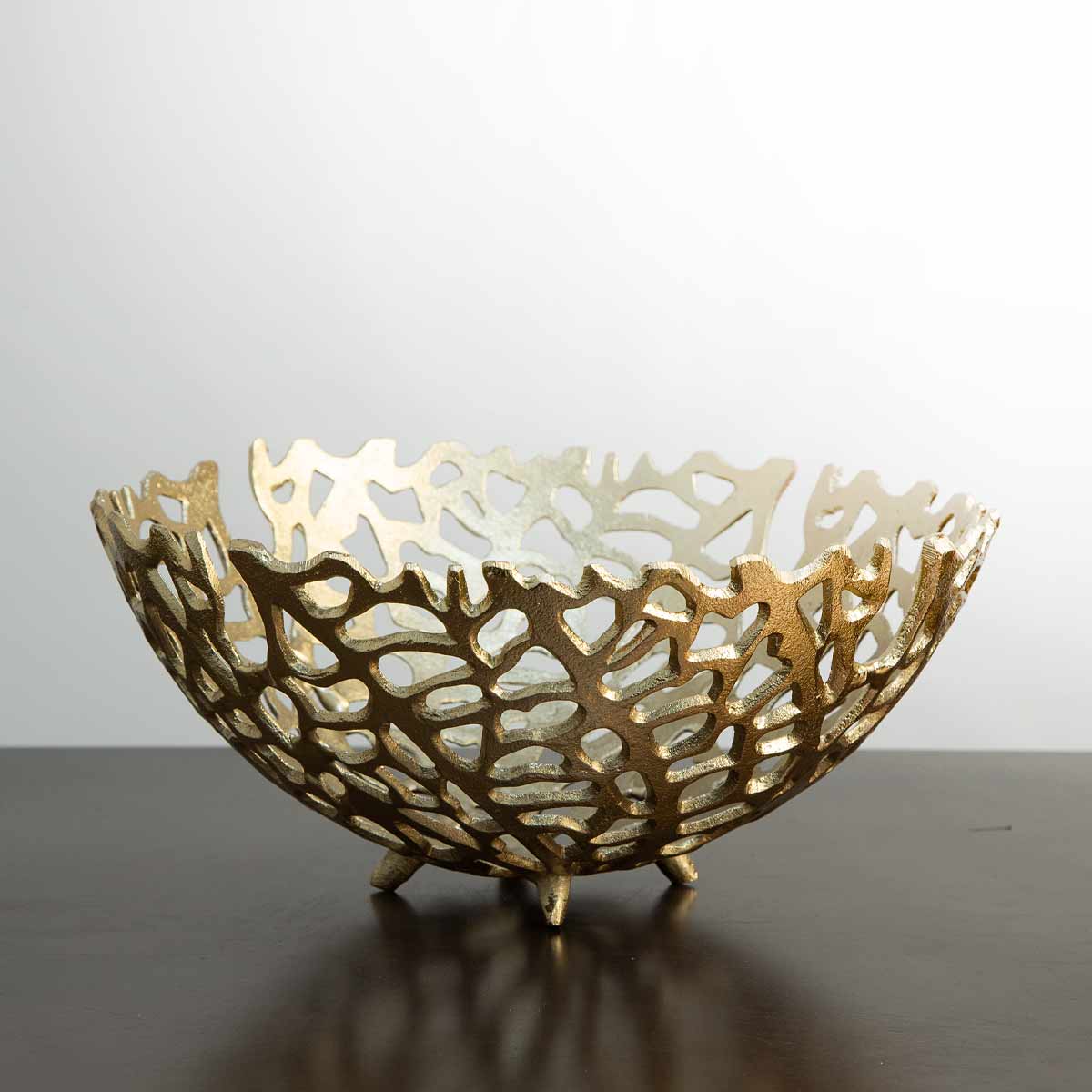 Antique gold coral-effect bowl styled on a coffee table