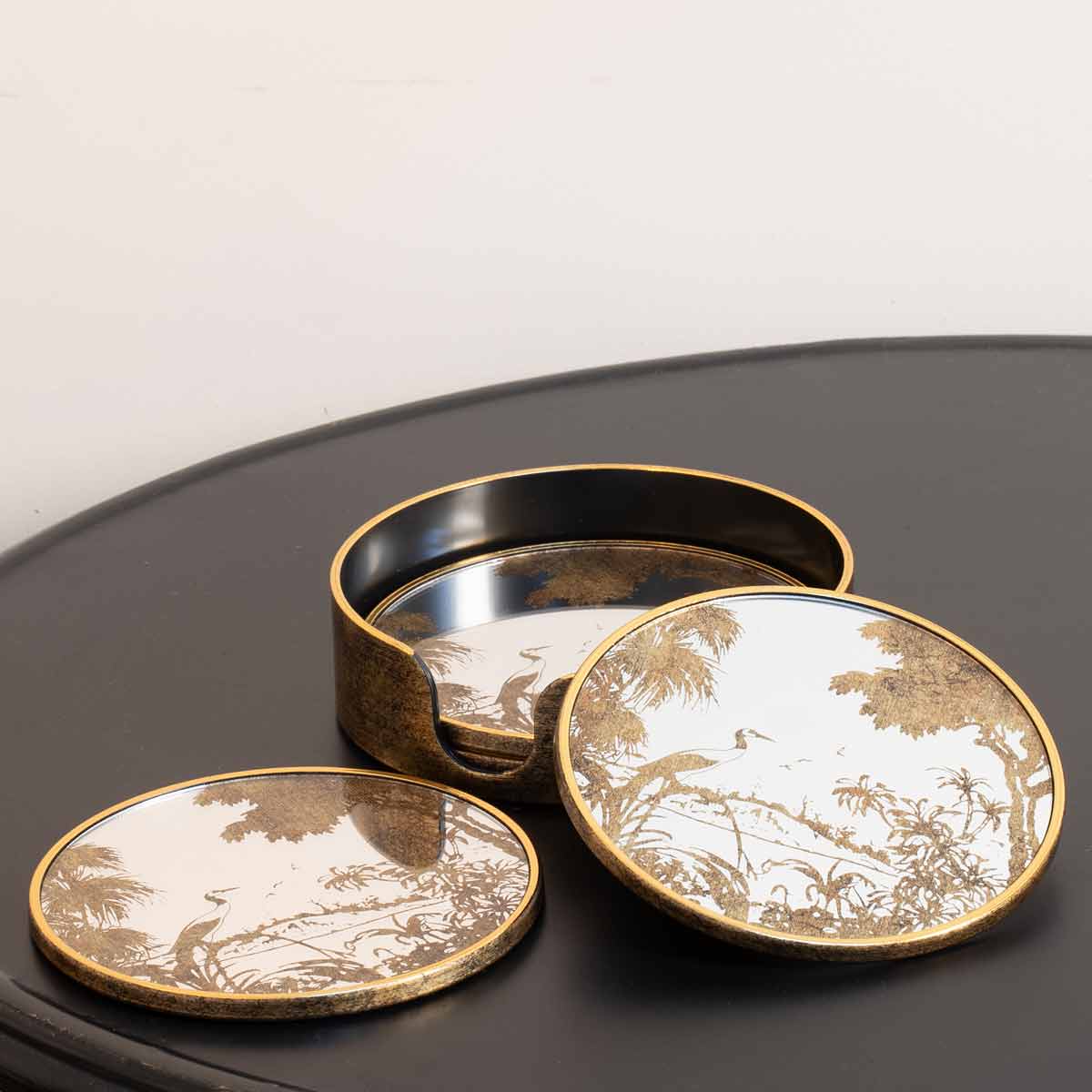 Antique Gold Crane Coasters in holder – styled top-down with matching tray on wooden surface