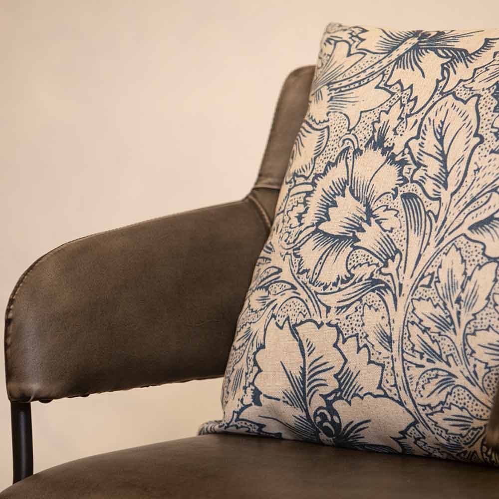 Bingham Floral Cushion in Blue styled on a grey leather Dining Chair