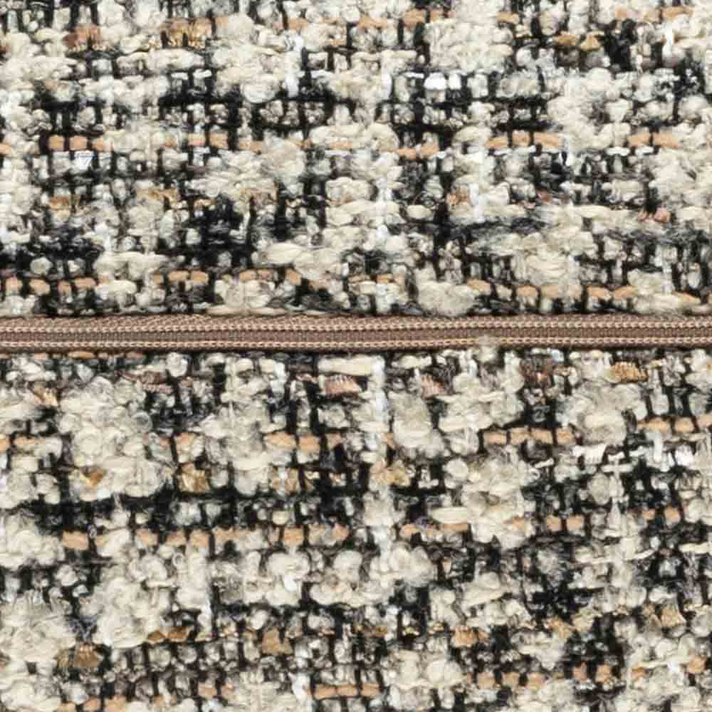 Close-up of a textured fabric with a zipper, featuring black, white, and beige colors.