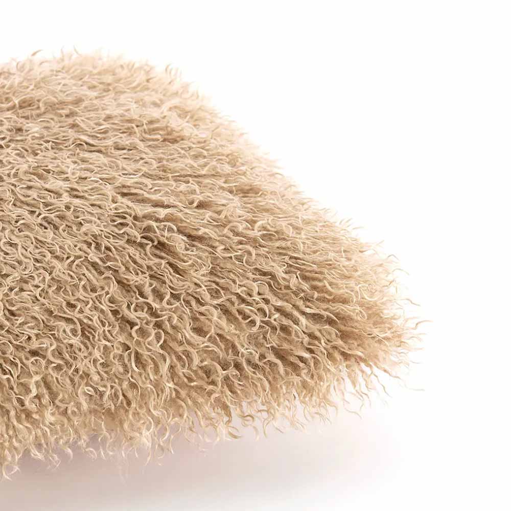 Close-up of a Bubion Faux Fur Square Cushion - Sand with shaggy texture on a white background