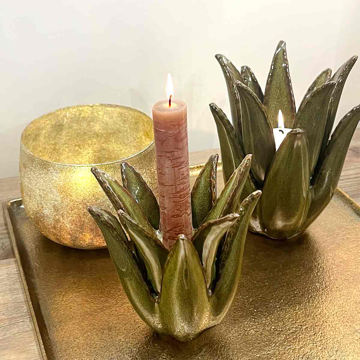 Cactus Ceramic Candlestick in dark green, styled with a lit dinner candle, paired with a gold-finished votive and displayed on a metallic tray, showcasing its unique design and glossy ceramic finish.