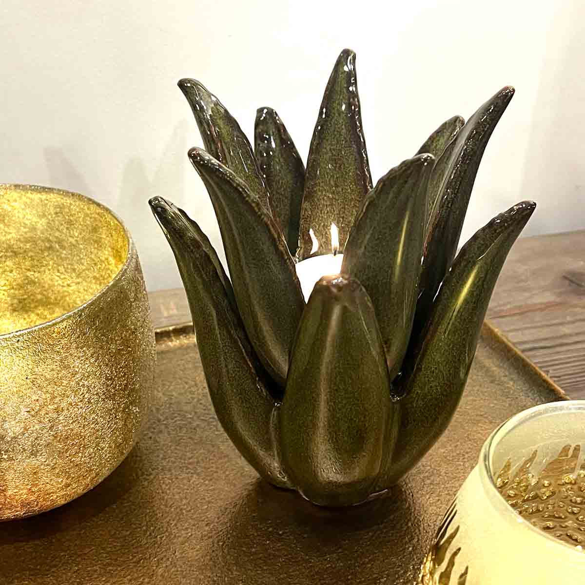 Cactus Ceramic Tealight Holder in dark green, styled with gold-toned candle holders on a decorative tray.