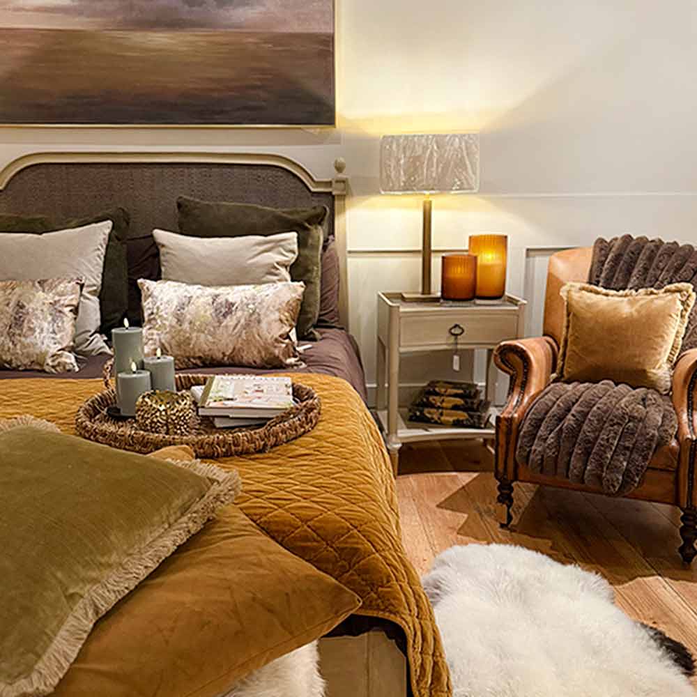 Bed with Caramel Bed Spread - King Size, green throw blanket, and decorative pillows in a bedroom setting.