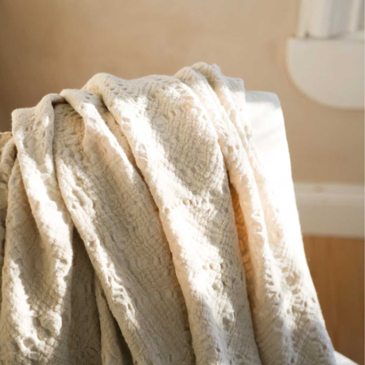 Lightweight Chantilly Throw – draped over chair in rustic room setting with natural light