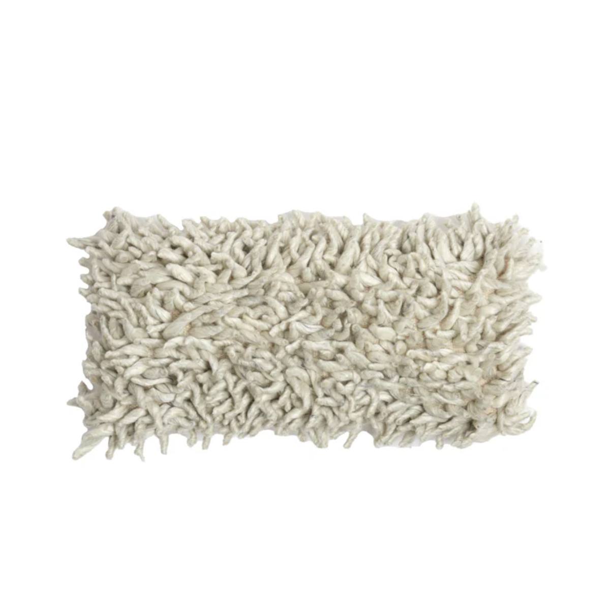 Close-up of a textured comallo oblong cushion in natural on a white background