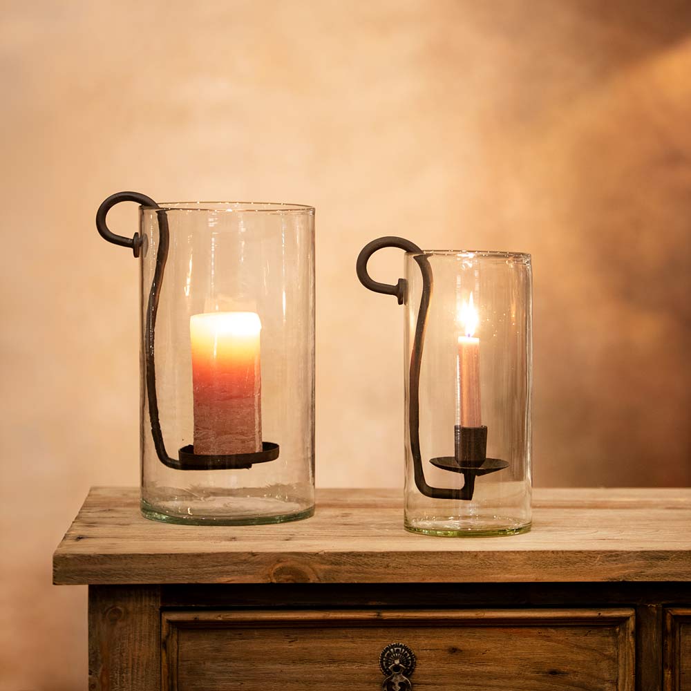 Dolega glass hurricane for dinner candle styled next to a hurricane for pillar candles on a rustic wooden console table