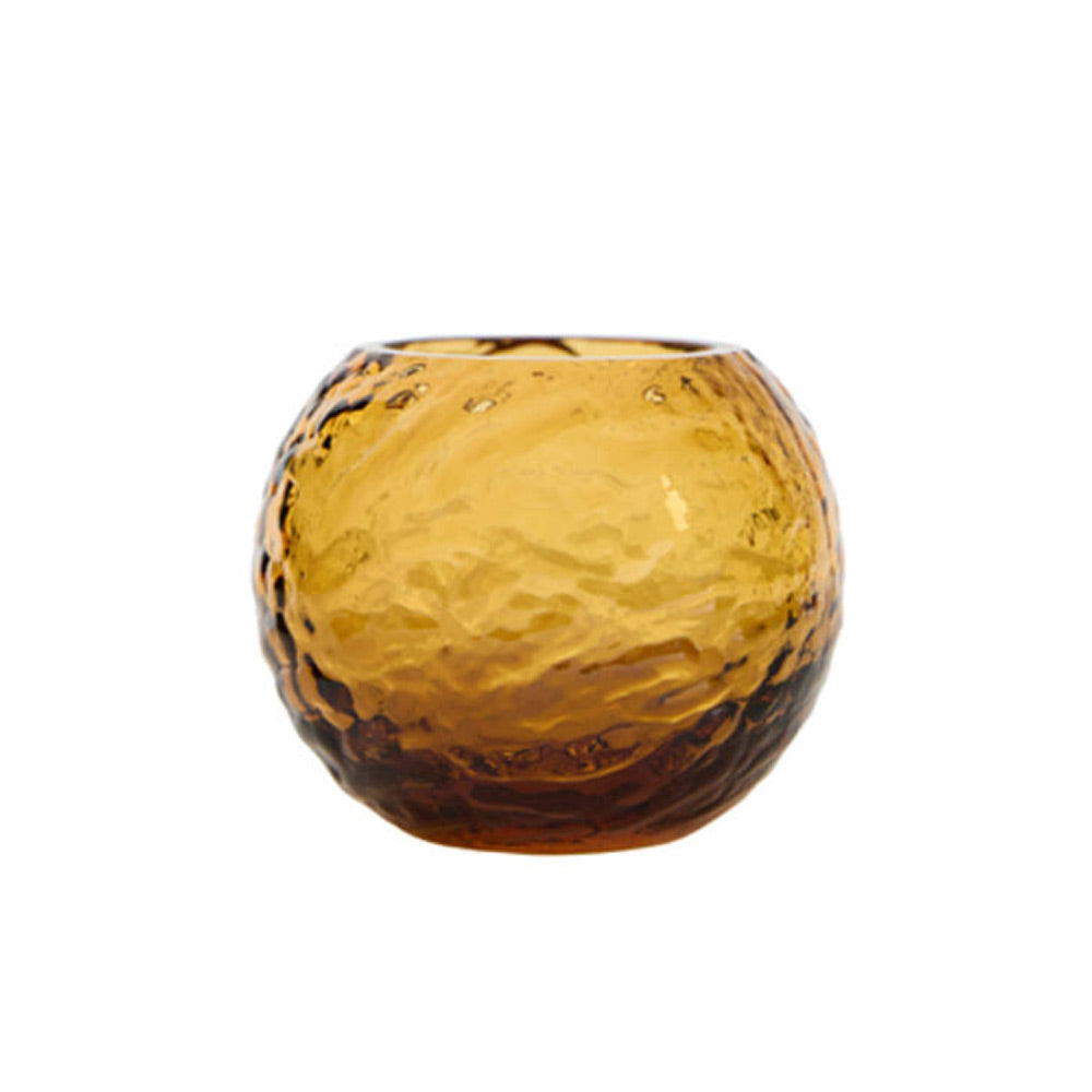 A small round amber glass candle holder with a textured, hammered finish, shown on a plain white background.