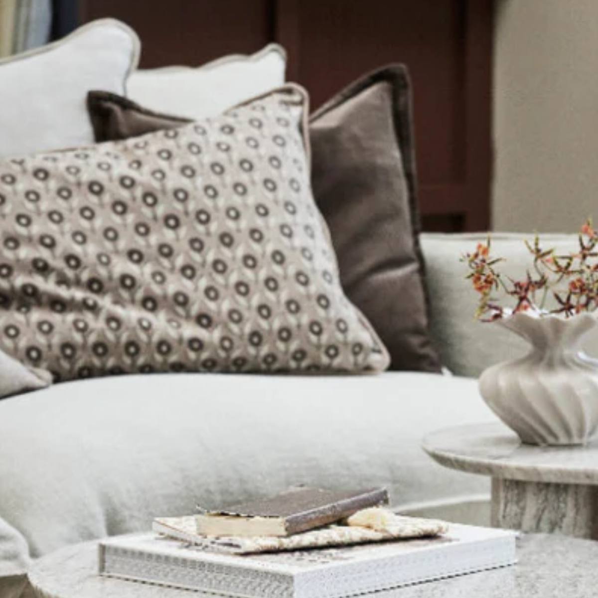 Efilia Oblong Flower Print Cushion - Dark Linen - Styled on beige sofa with cushions