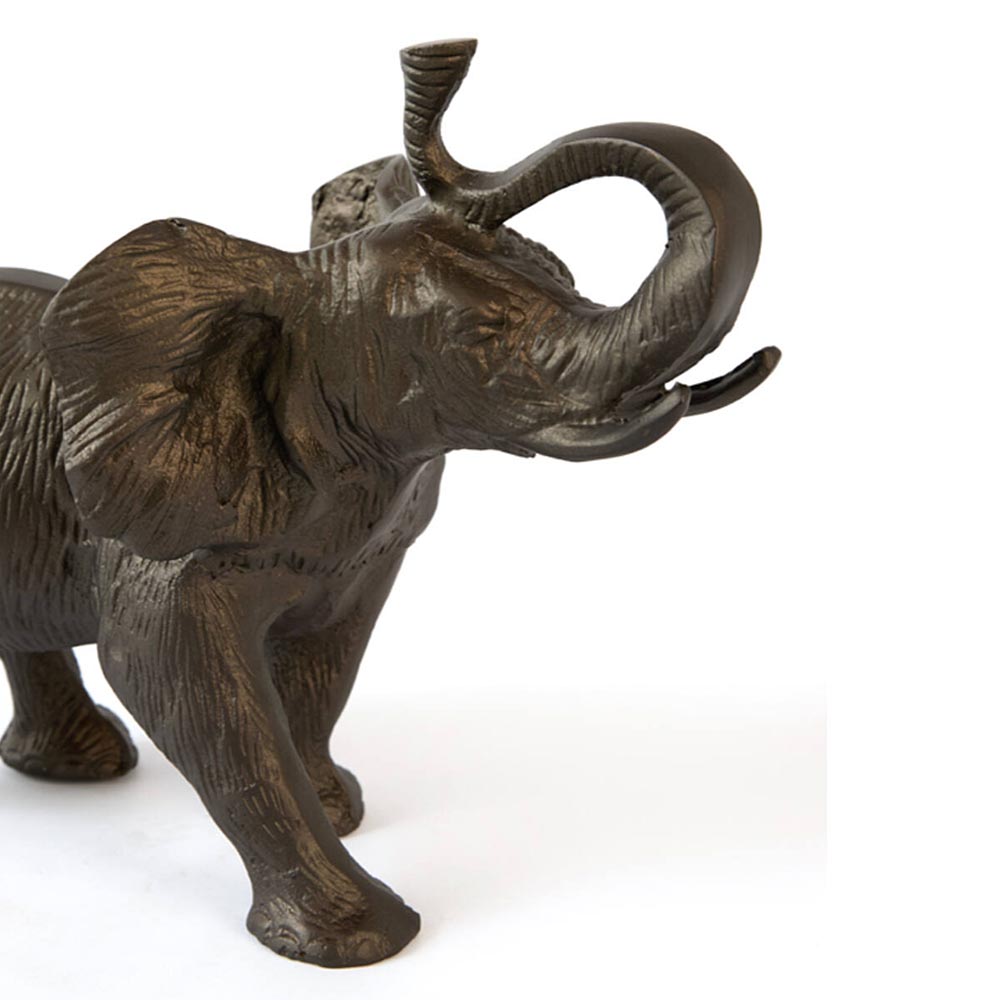close up of A dark bronze-finished elephant figurine with textured details, shown from a side profile against a plain white background.