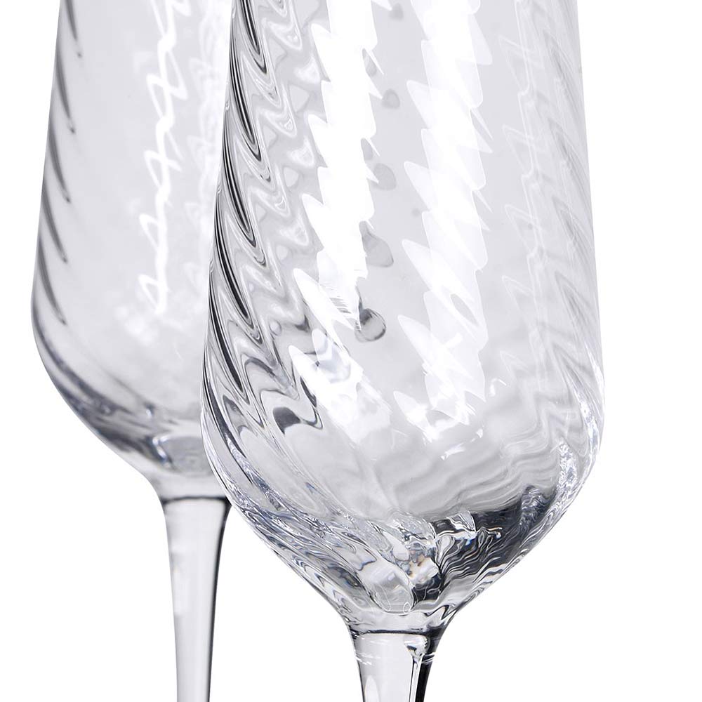 Etta clear glass champagne flute with textured design on a white background