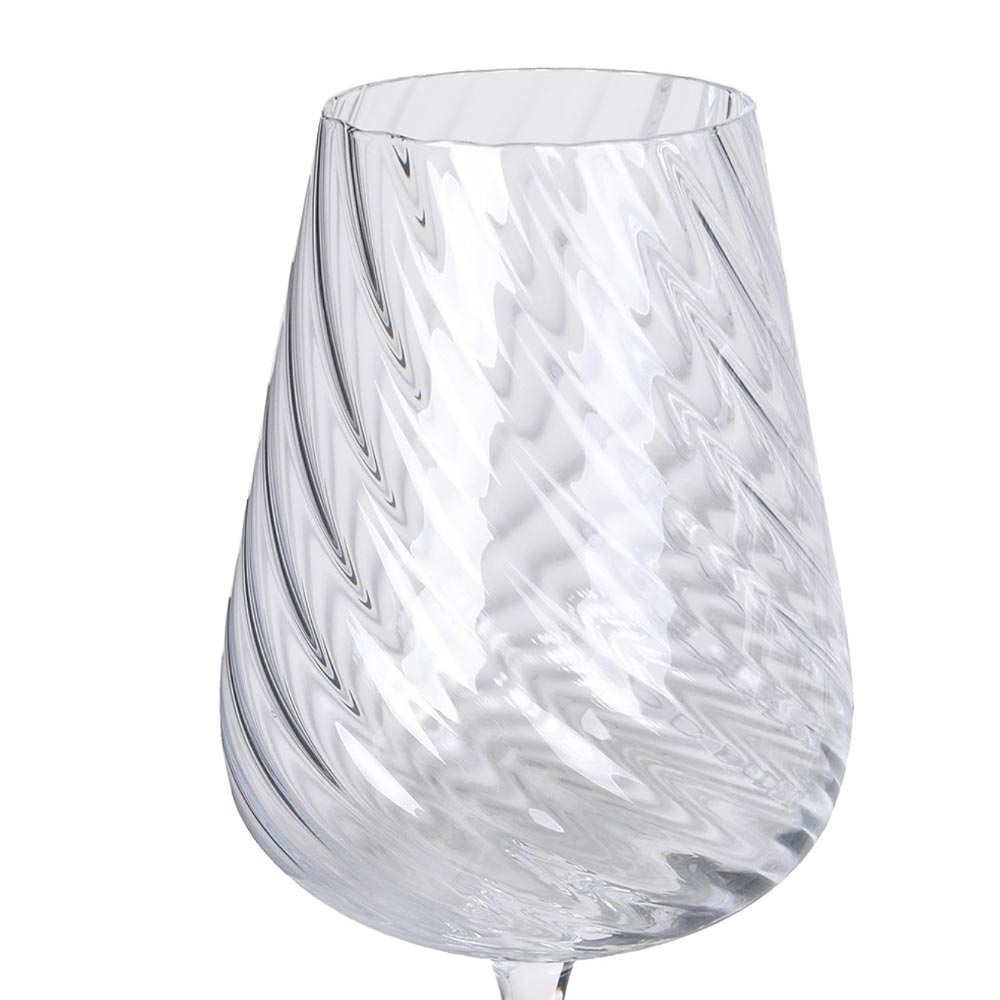 Close up of clear Etta White Wine Glass with swirling pattern on a white background