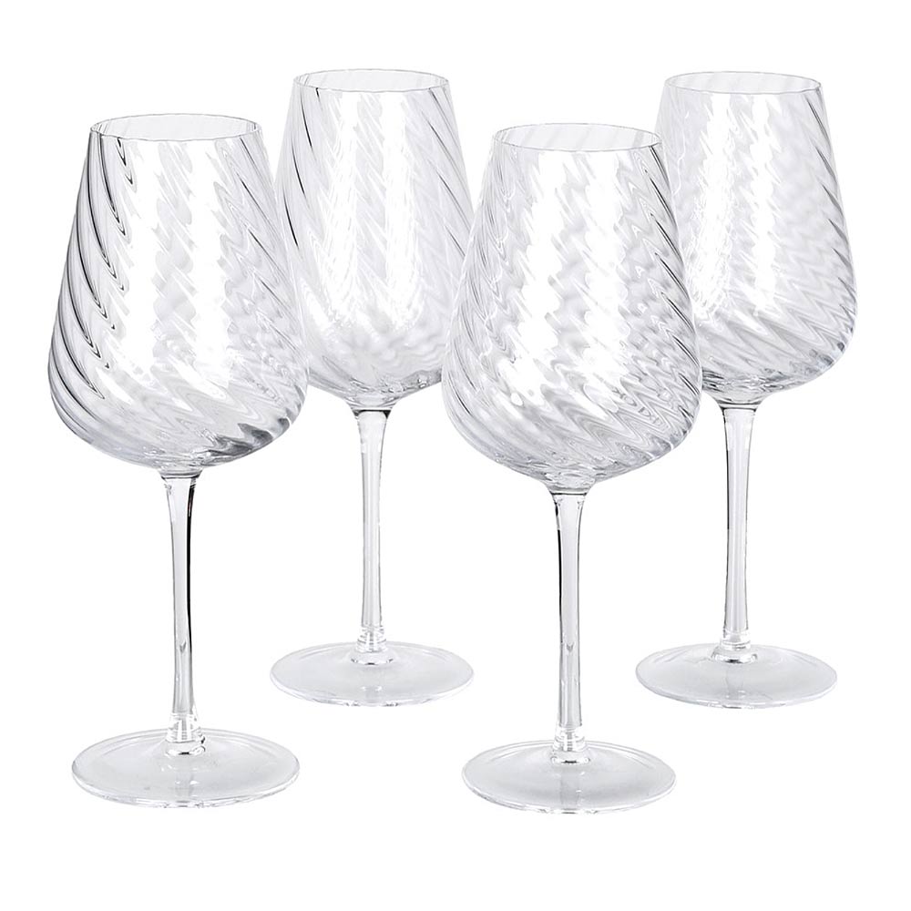 Four spiral cut Etta white wine glasses on a wooden surface on a white background