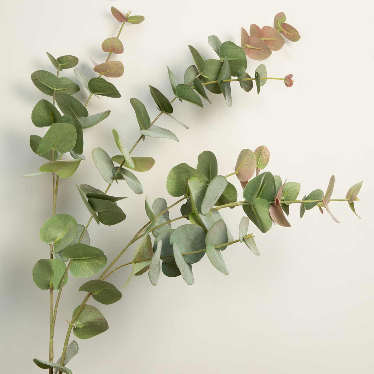 Close up of leaves - Faux Eucalyptus Tall Spray in Rose - artificial leaves on a neutral background