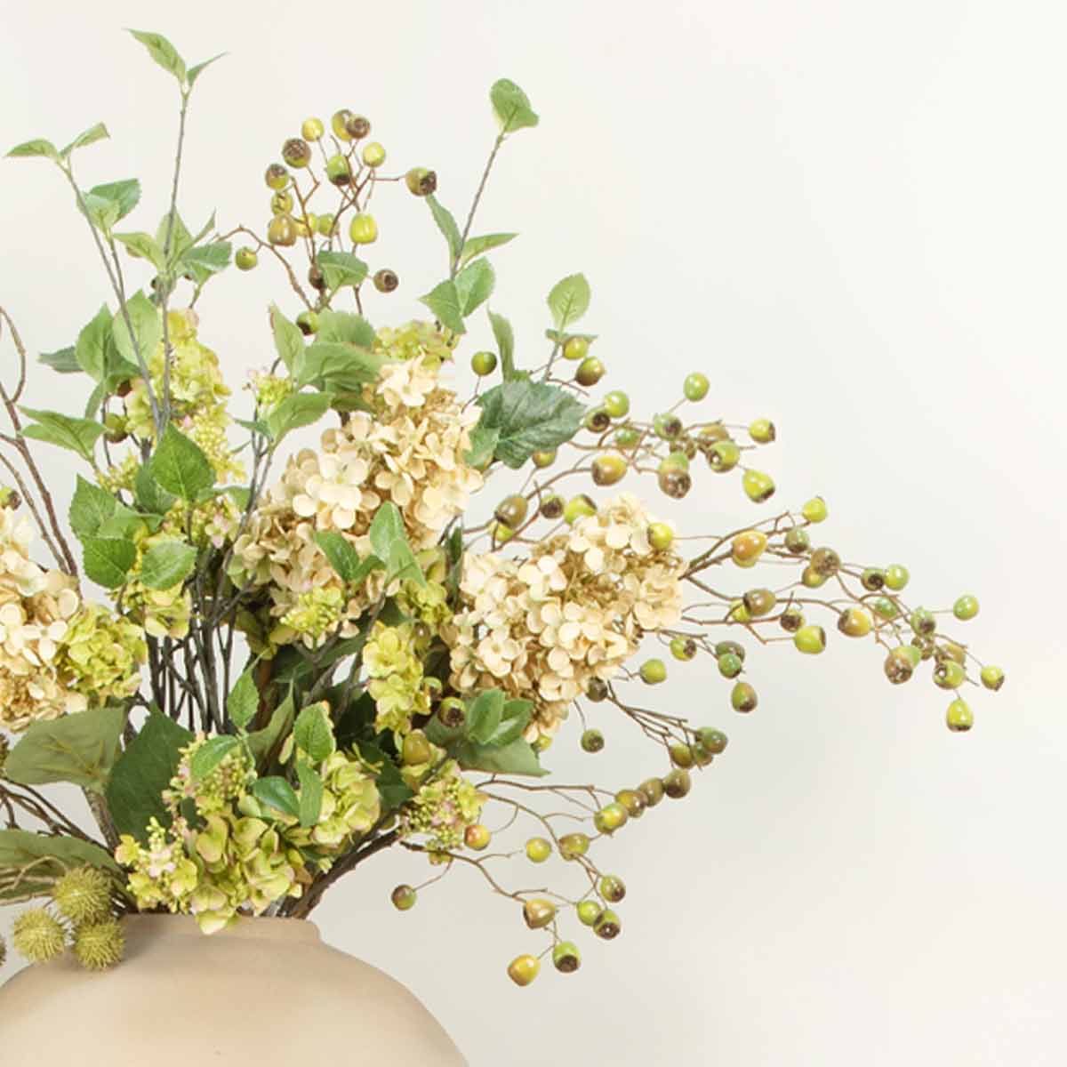 Artificial green hydrangea spray styled with dual tone eucalyptus berry and cream cone hydrangeas in a cement vase
