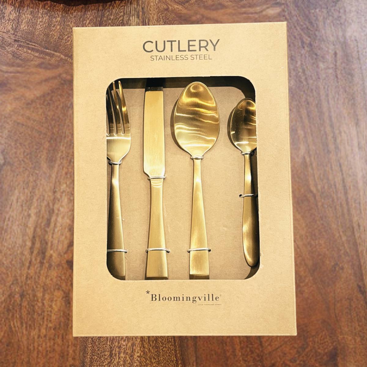 Frea Stainless Steel Cutlery Set in Gold - placed in packaging on a wooden surface