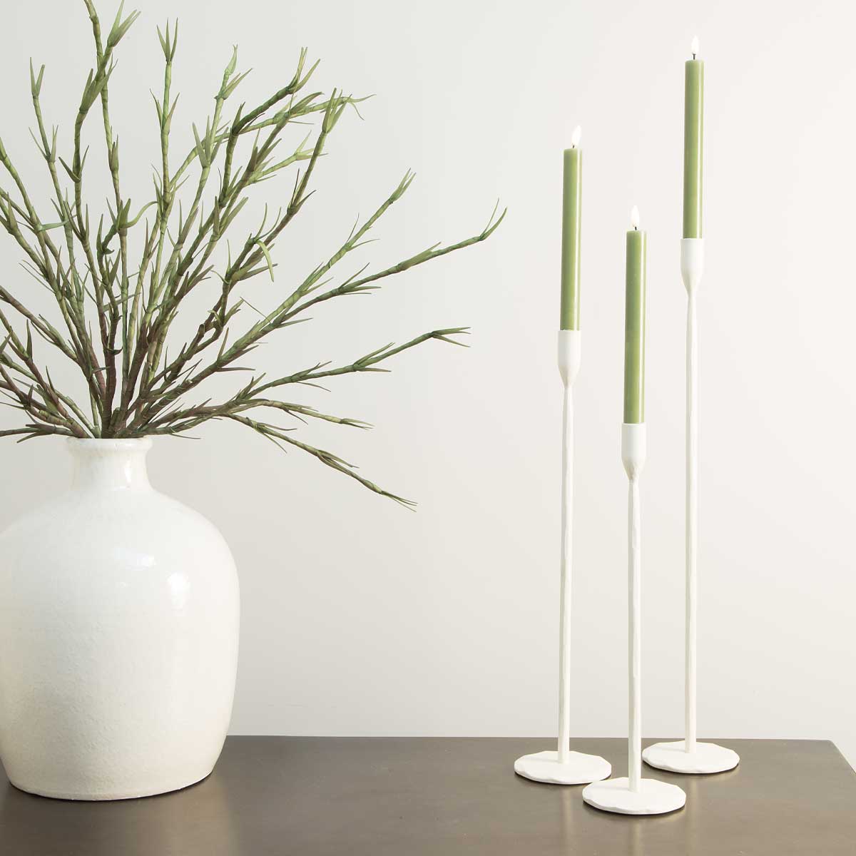 Icarus Candlesticks in Cream – 3 sizes styled with olive green candles and white ceramic vase with faux greenery