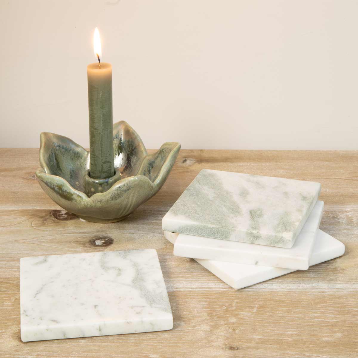 A set of four handcrafted Lady Onyx marble coasters with natural green and pink veining, ethically sourced from Agra, India.