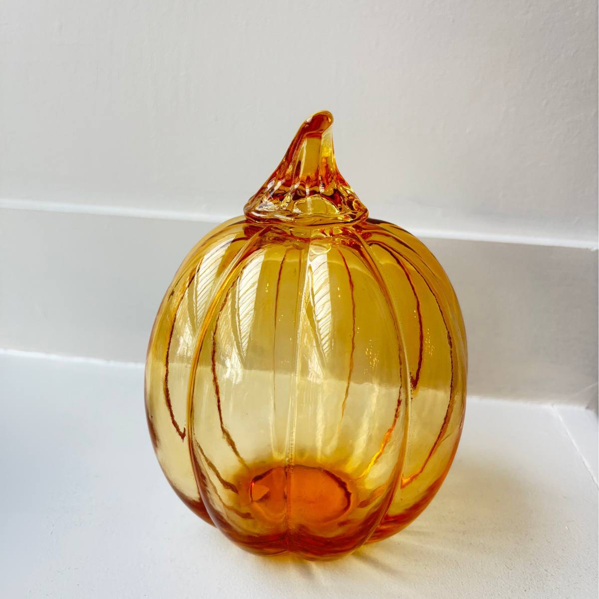 Light Amber - Large glass pumpkin on a white background