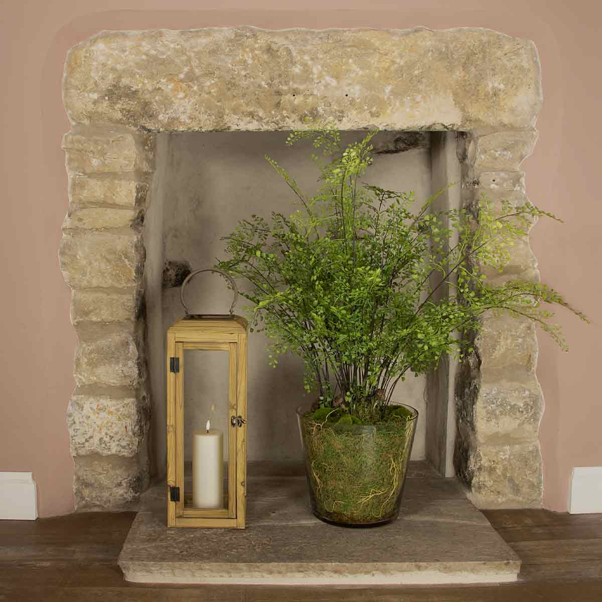 Small Lilly Wooden Lantern – natural wood and glass lanterns styled in a stone fireplace with candles and greenery
