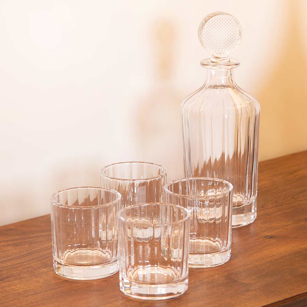 Luxe Glass Decanter Set with four glass tumblers styled on wooden console