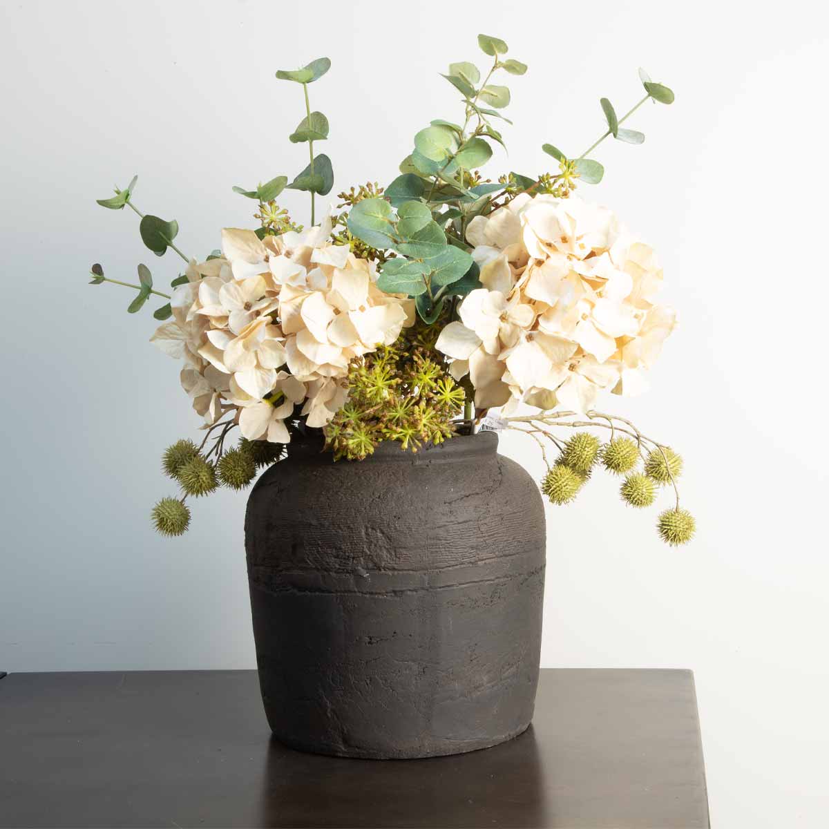 Madrid Charcoal Vase filled with faux cream hydrangeas and eucalyptus stems