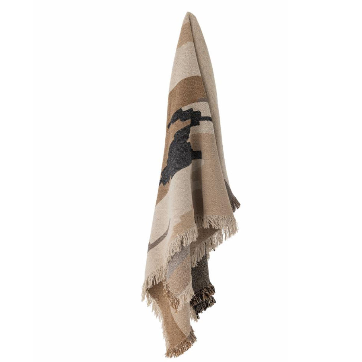 Maji Throw – a woven recycled cotton blanket in warm brown and beige tones with a subtle geometric pattern and fringed edges - displayed hanging up.