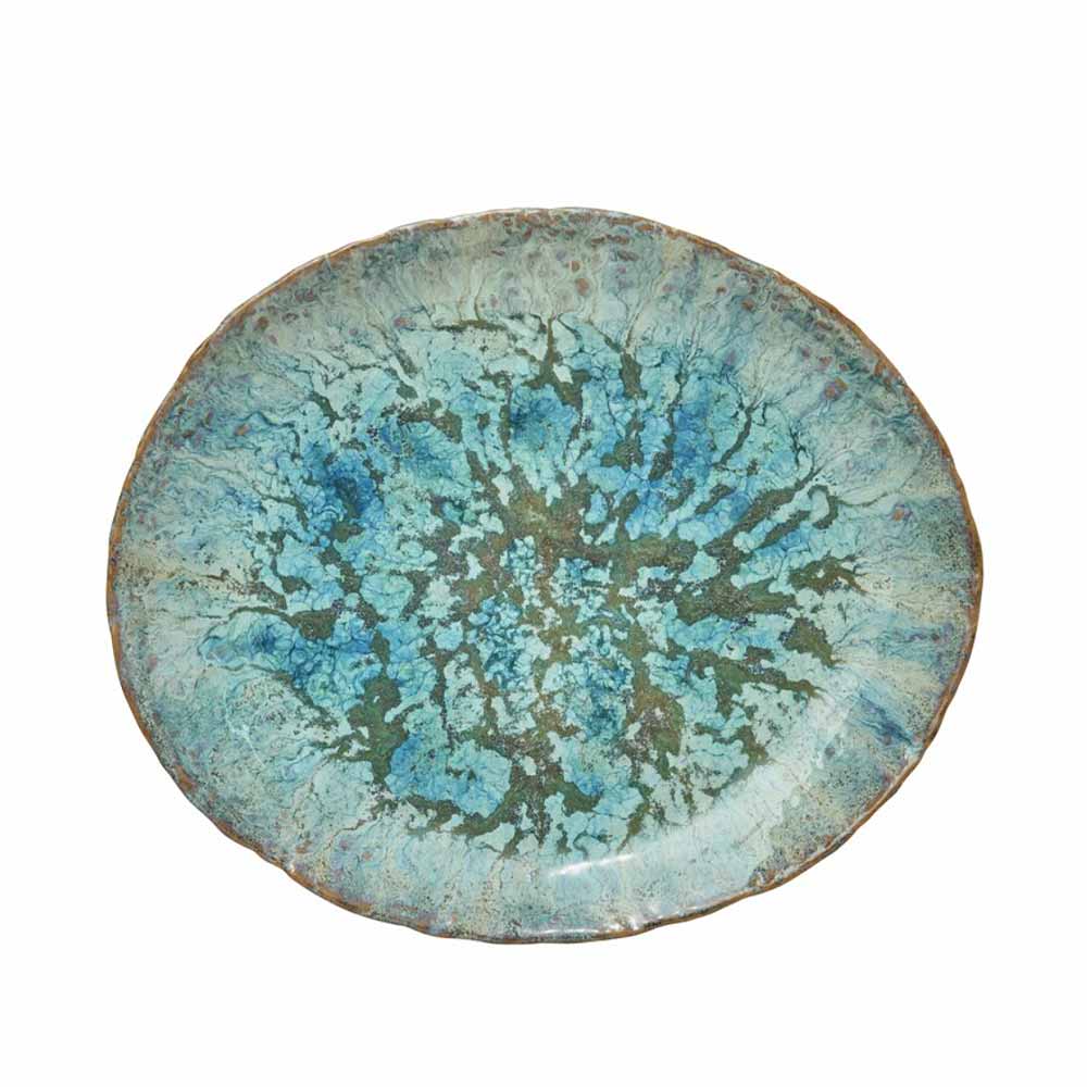 Round Milla ceramic plate with blue and green reactive glaze on a white background