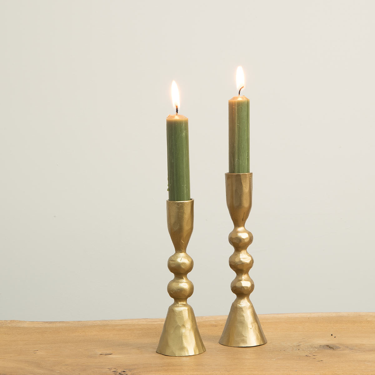 Mitzi gold candlesticks with green taper candles – Art Deco-inspired design