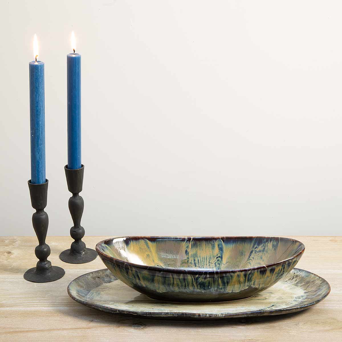 Ocean Glaze Decorative Plate styled with matching bowl and candles on a wooden table.