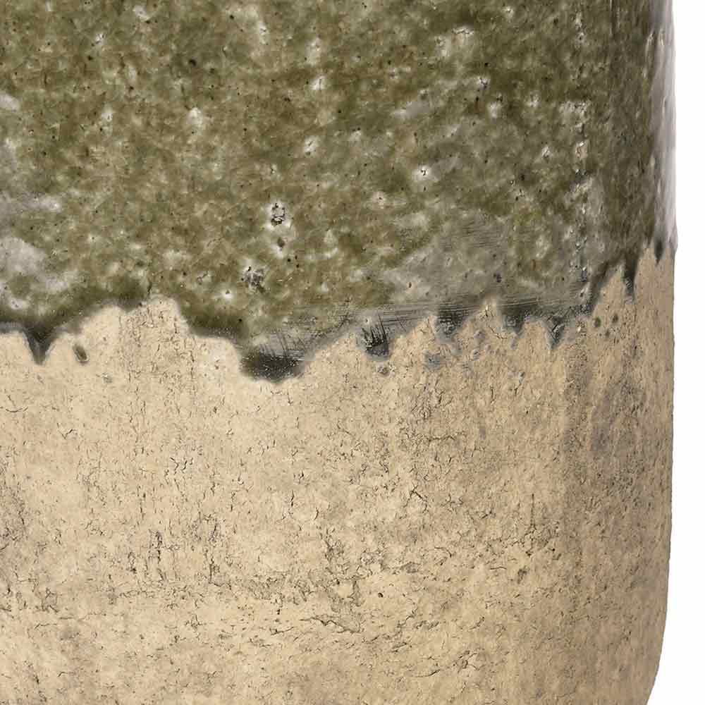Close-up of a ceramic vessel showing a two-tone glaze transition from textured olive green at the top to warm sandy beige at the bottom.