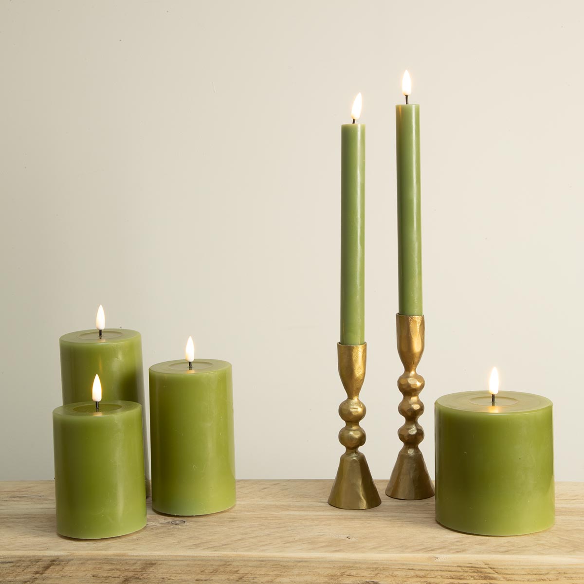 Olive green LED dinner and pillar candles on wooden table – battery-operated, real wax finish