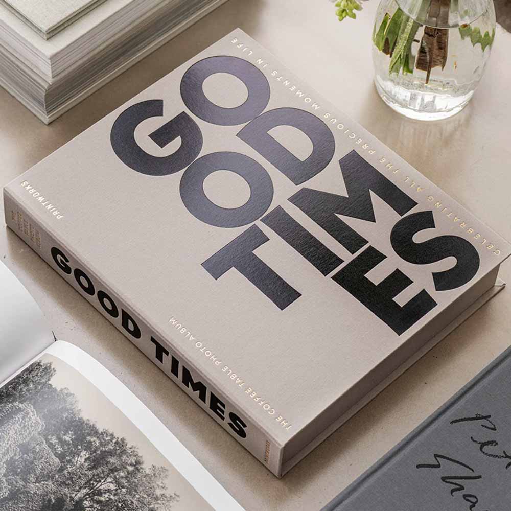 Good Times Photo Album in grey on a table with a plant in the background