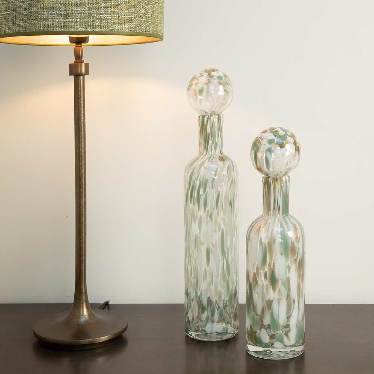 Decorative Glass Bottle with Pistachio, Gold & White Mottled Finish - Two Sizes Shown (Large and Small) - Displayed with lamp