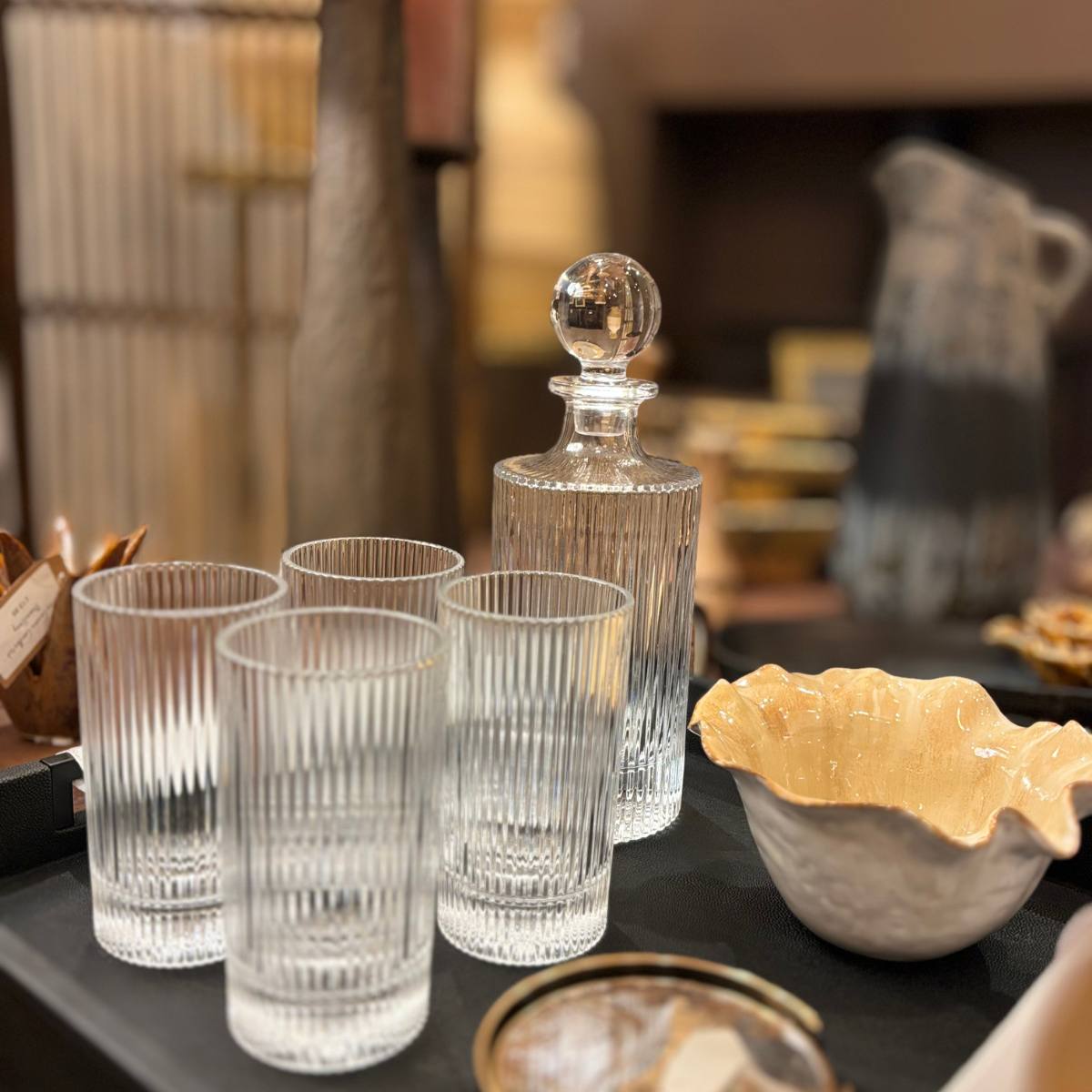 Ribbed Glass Decanter and Glass Set displayed on black tray on table with ceramics
