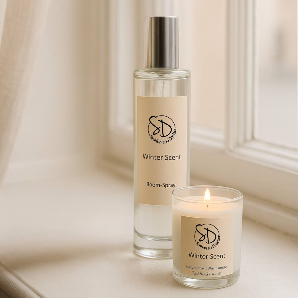 100ml Winter Room Spray in clear glass bottle shown on window sill with Winter Scent Votive