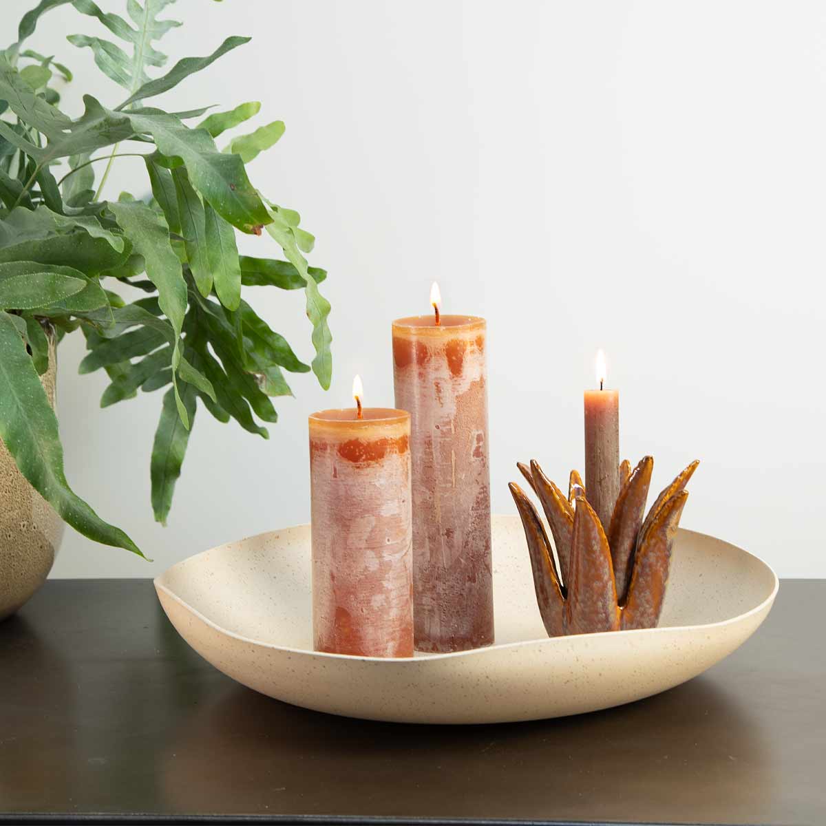 Cognac Rustic Pillar Candles styled on a neutral bowl with a ceramic candle holder