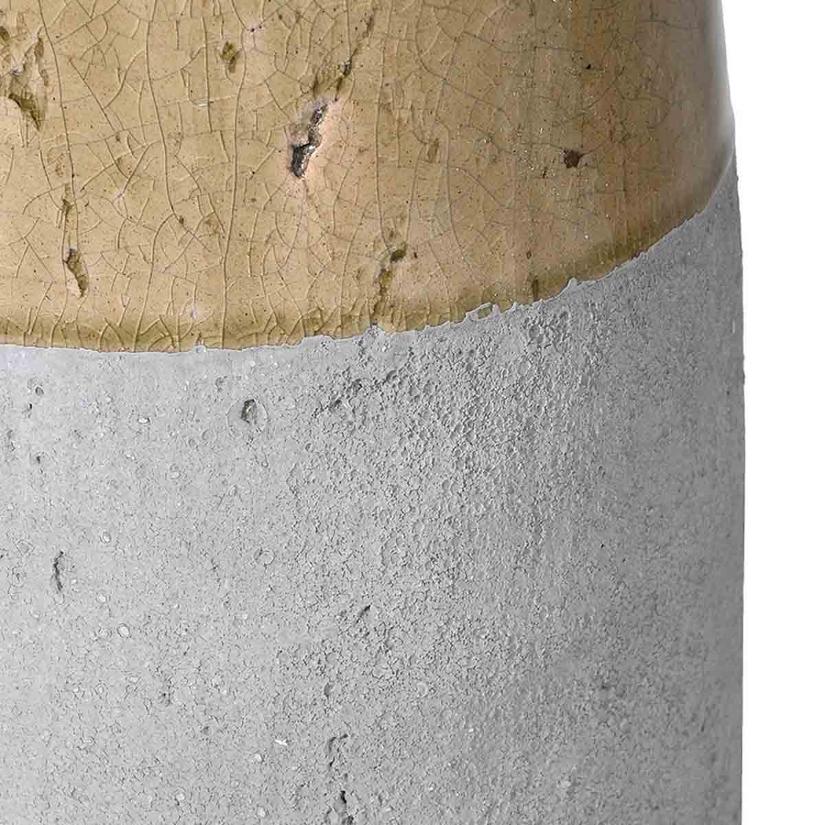 Rustic two-toned ceramic vase with a tall, tapered shape and a curved handle, featuring a glazed upper half in warm beige and an unglazed textured base in light grey.