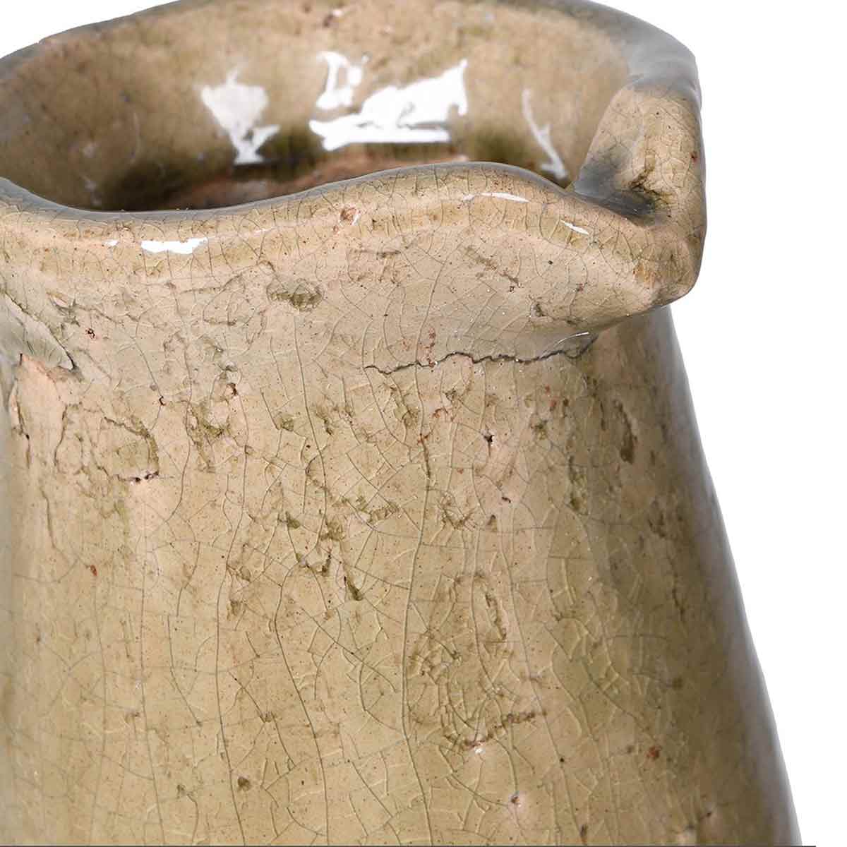 Rustic two-toned ceramic vase with a tall, tapered shape and a curved handle, featuring a glazed upper half in warm beige and an unglazed textured base in light grey.