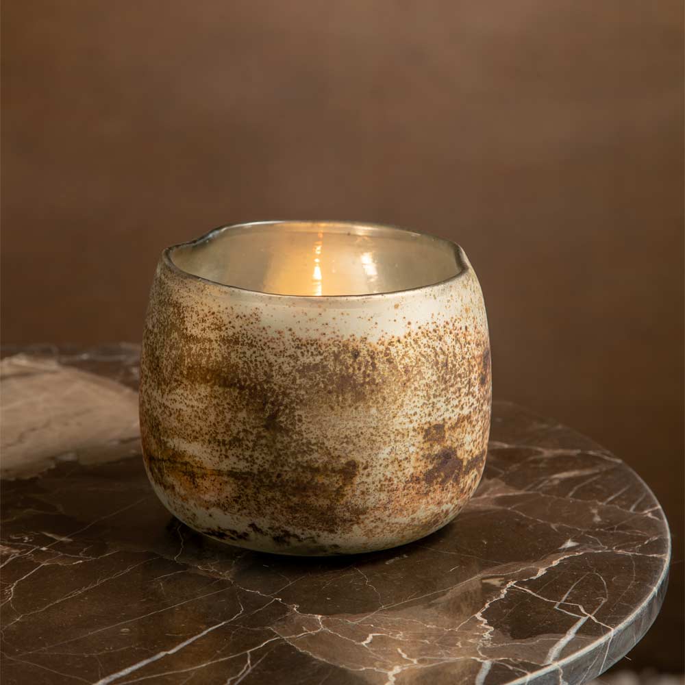large Sungai Antique Gold Glass Candle Holder on a brown marble table