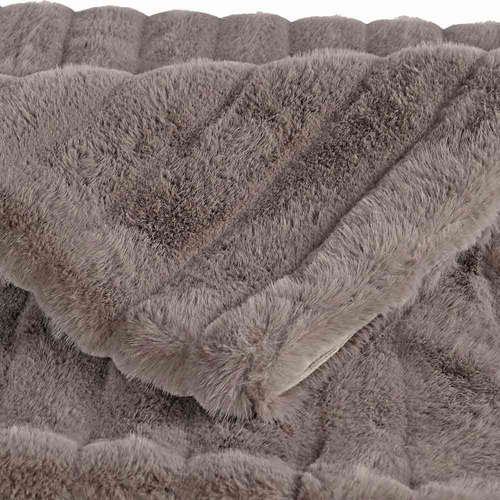 Close-up of a plush faux fur blanket in a warm gray-brown color, showing the soft texture and stitched quilted pattern.