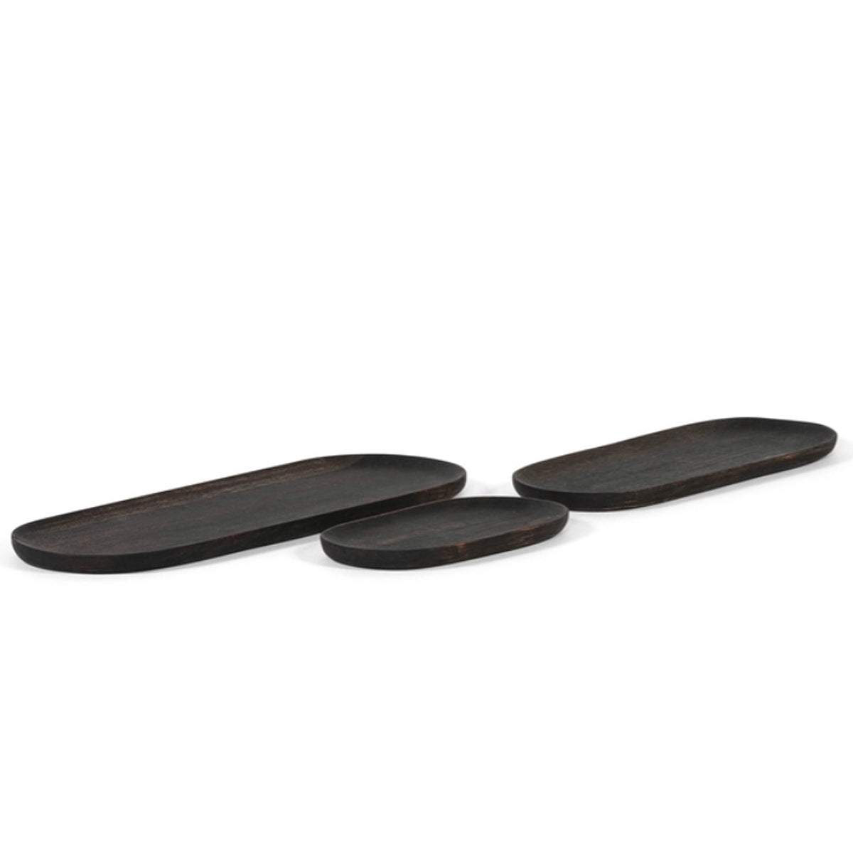 Set of three black oiled acacia wooden long candle plates in small, medium, and large with smooth oval shapes and raised edges.