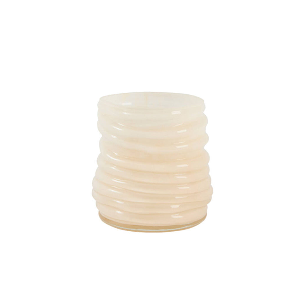 A small cylindrical ribbed glass candle holder or vase in a warm cream or pale peach colour, shown on a solid white background.