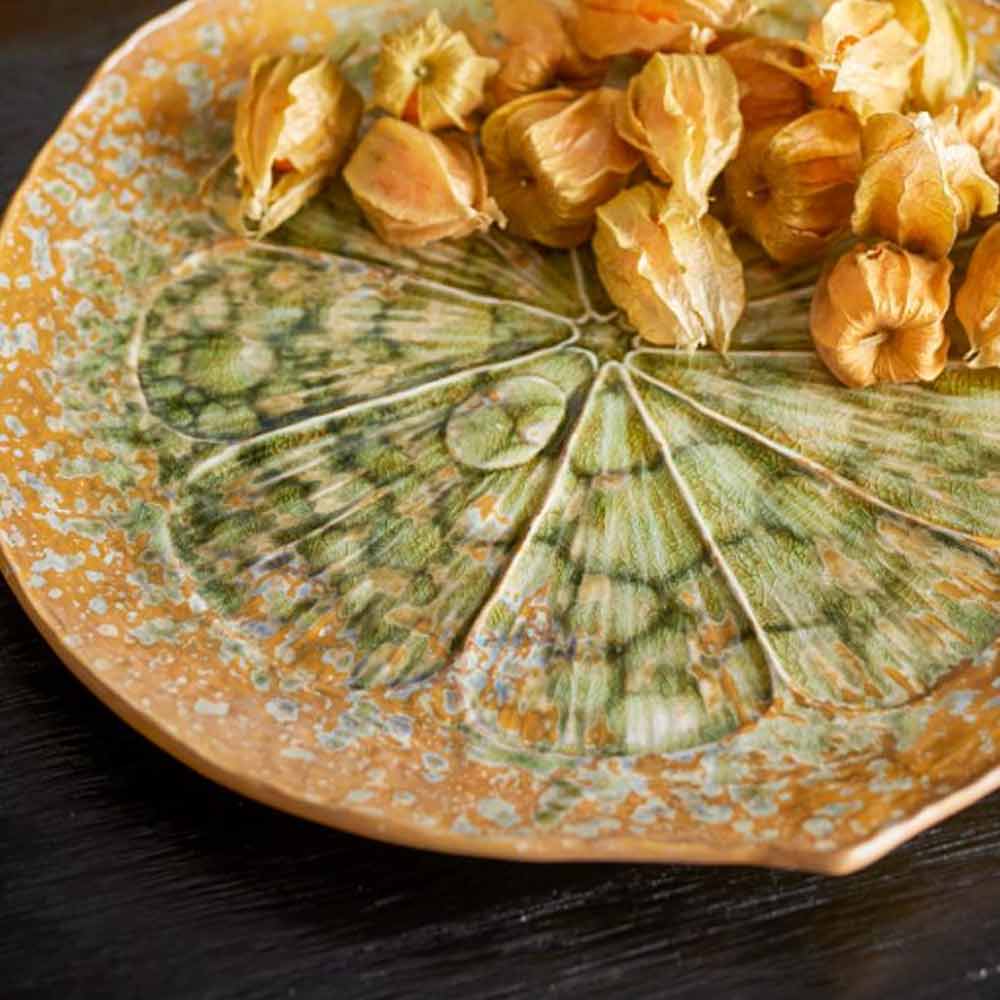 Milani stoneware serving dish with citrus-inspired green glaze – top view with food
